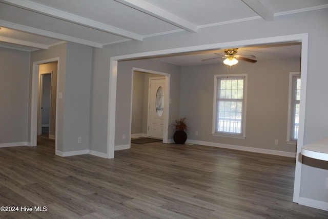 unfurnished living room with beamed ceiling, dark hardwood / wood-style flooring, ceiling fan, and ornamental molding