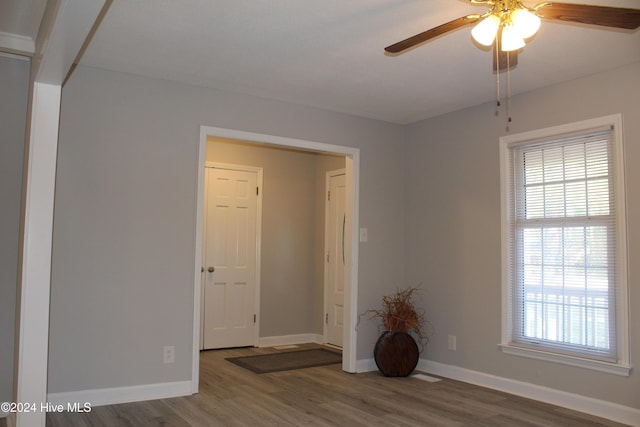 unfurnished room with hardwood / wood-style floors and ceiling fan