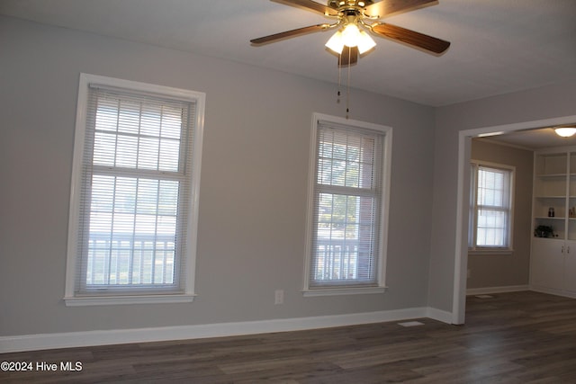 empty room featuring ceiling fan and dark hardwood / wood-style flooring