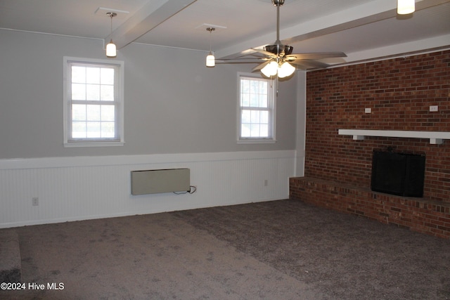 unfurnished living room with beamed ceiling, carpet flooring, a healthy amount of sunlight, and ceiling fan