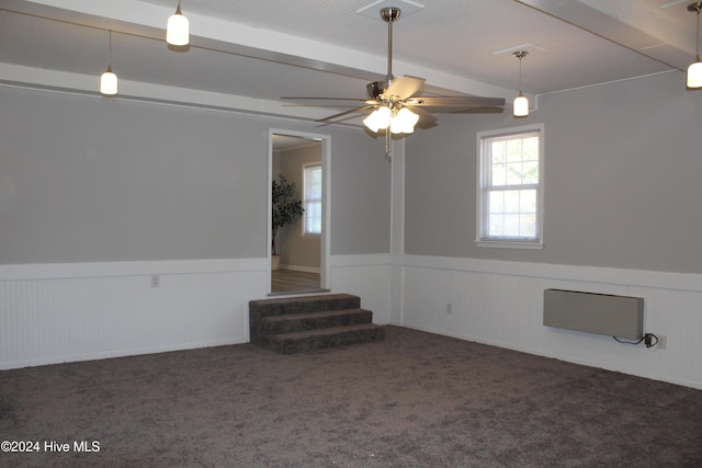 carpeted empty room with an AC wall unit, vaulted ceiling with beams, and ceiling fan