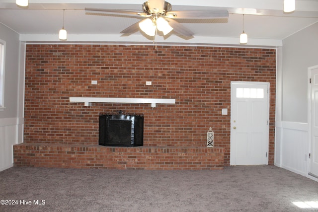 unfurnished living room with ceiling fan and carpet floors