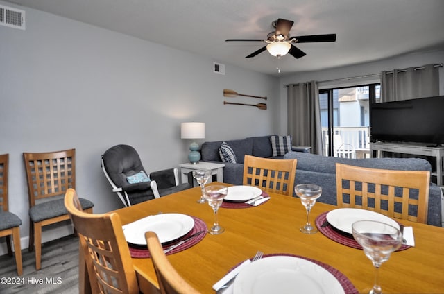 dining space with hardwood / wood-style floors and ceiling fan