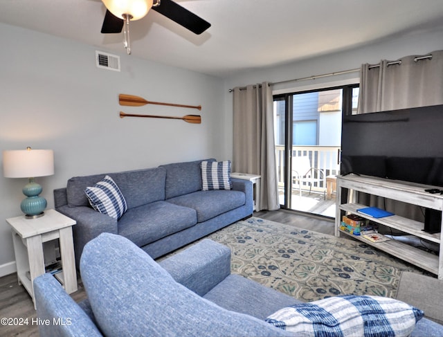 living room featuring ceiling fan and wood-type flooring