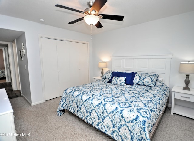 bedroom featuring ceiling fan, a closet, and light carpet