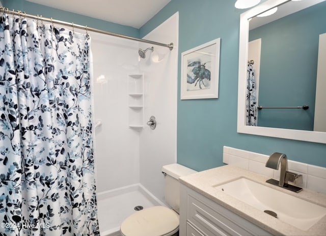 bathroom with a shower with curtain, vanity, and toilet