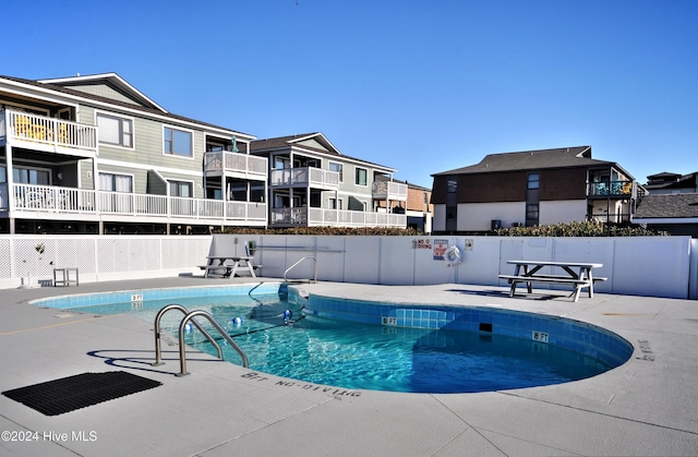 view of swimming pool with a patio area