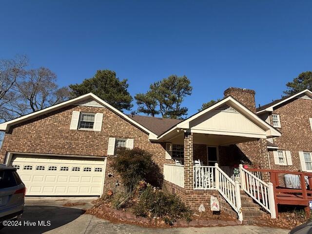 view of front facade with covered porch and a garage