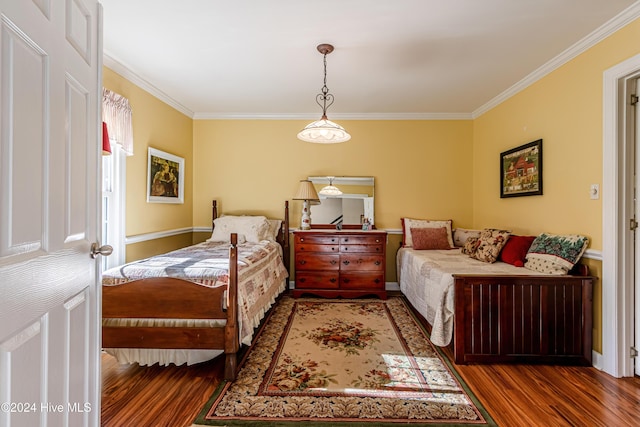 bedroom featuring ornamental molding and dark wood-type flooring