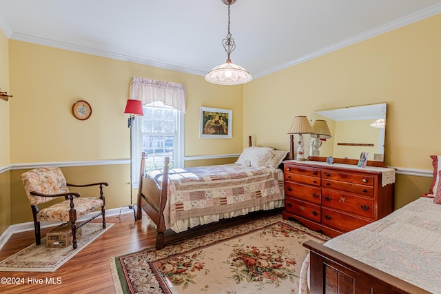 bedroom featuring light hardwood / wood-style floors and ornamental molding