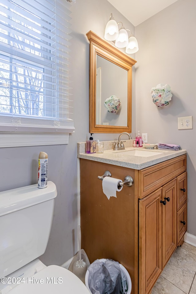 bathroom with tile patterned floors, vanity, and toilet