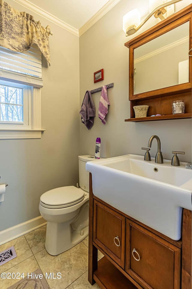 bathroom featuring tile patterned floors, vanity, toilet, and ornamental molding