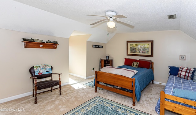 bedroom with a textured ceiling, ceiling fan, light colored carpet, and lofted ceiling