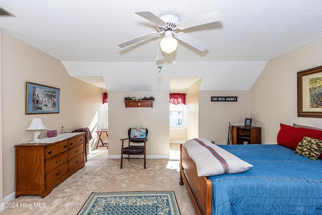 bedroom featuring a textured ceiling, ceiling fan, light colored carpet, and lofted ceiling