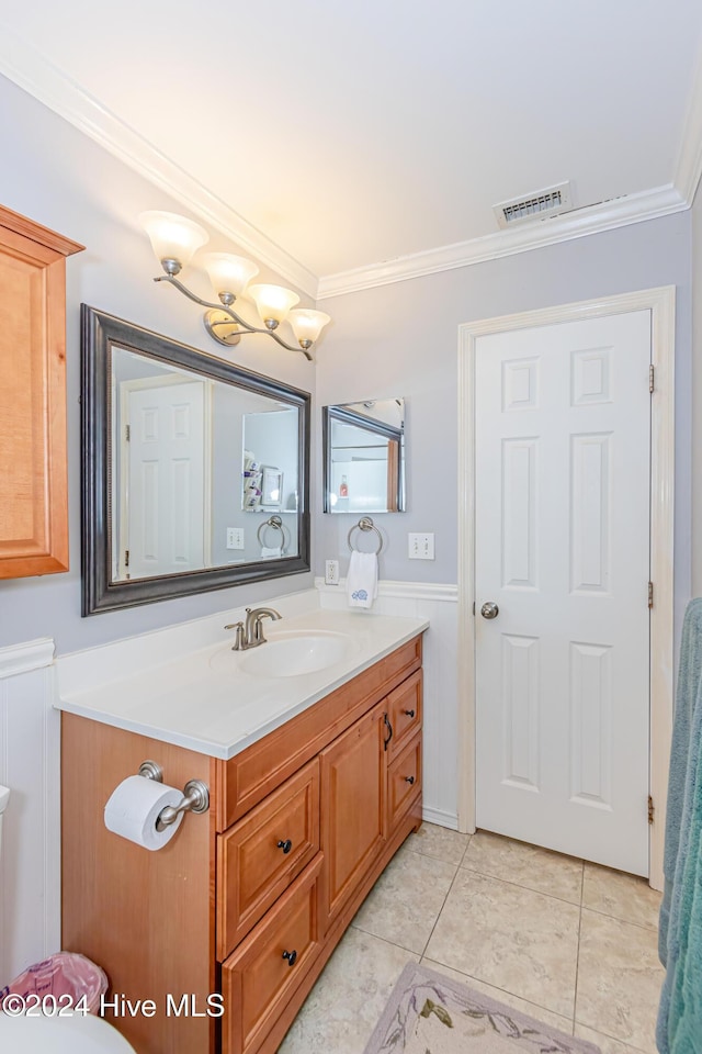 bathroom featuring vanity, tile patterned floors, and ornamental molding