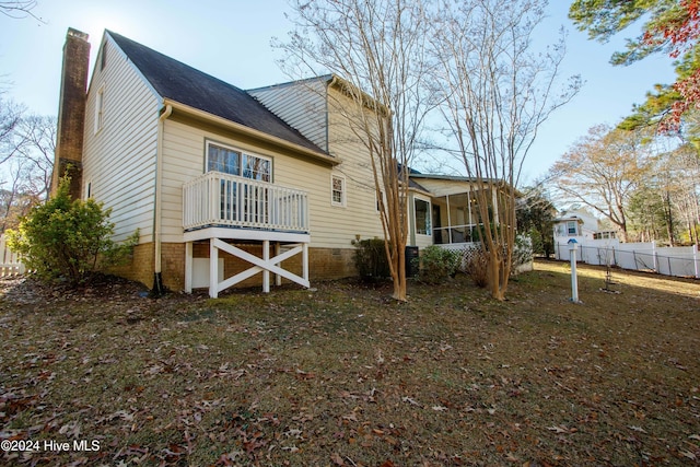 back of house featuring a sunroom