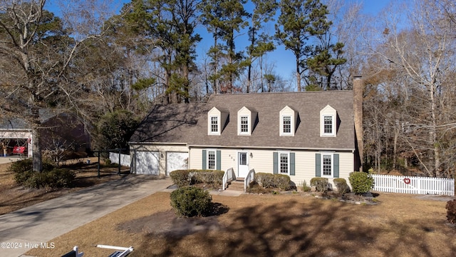 new england style home featuring a garage