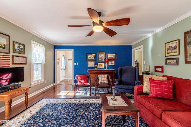 living room with hardwood / wood-style flooring, ceiling fan, and ornamental molding