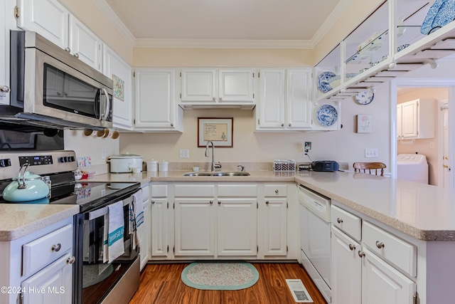 kitchen featuring sink, washer / clothes dryer, appliances with stainless steel finishes, white cabinets, and ornamental molding