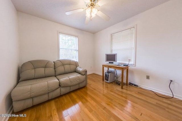 interior space with ceiling fan and hardwood / wood-style flooring