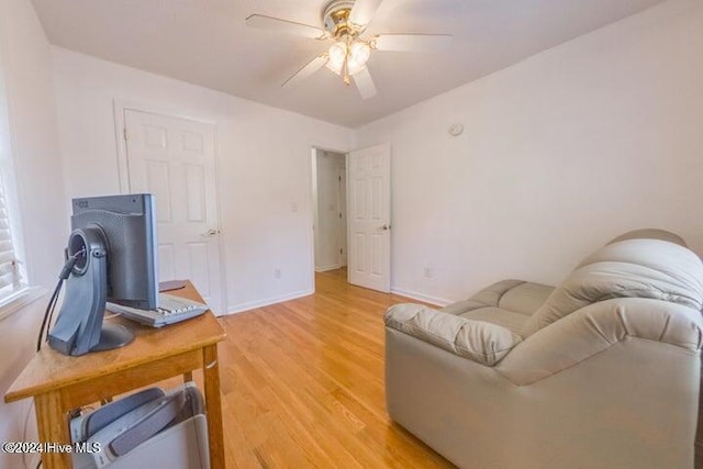 living room with ceiling fan and light hardwood / wood-style floors