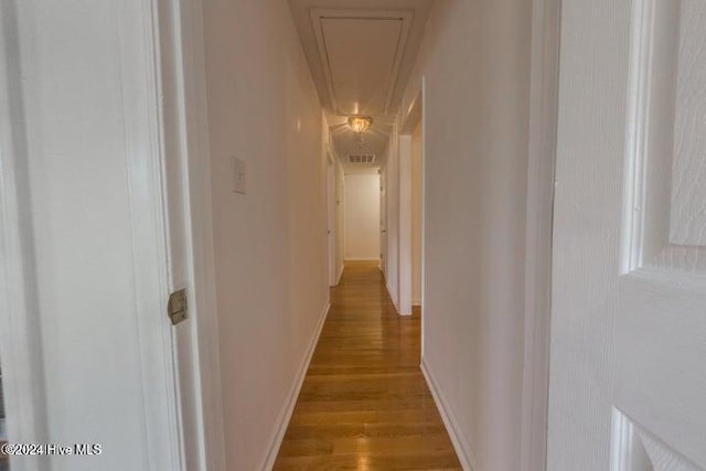 hallway with light hardwood / wood-style floors