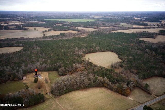 birds eye view of property with a rural view