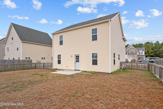 back of house with a yard and a patio area