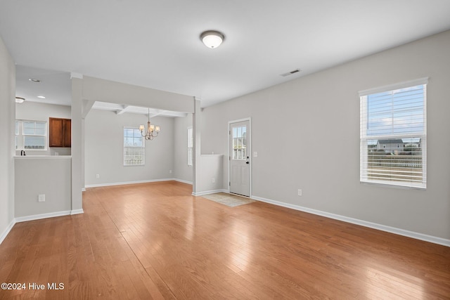 interior space featuring an inviting chandelier and light hardwood / wood-style floors