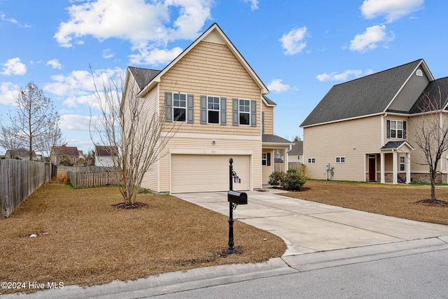 view of property featuring a garage and a front lawn