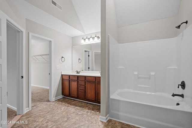 bathroom with vanity, shower / tub combination, and lofted ceiling