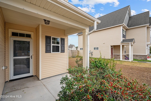 entrance to property featuring a patio