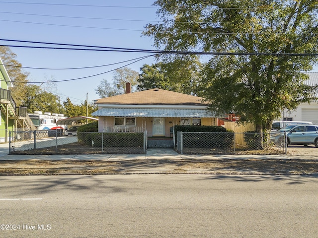 view of front of property featuring a carport