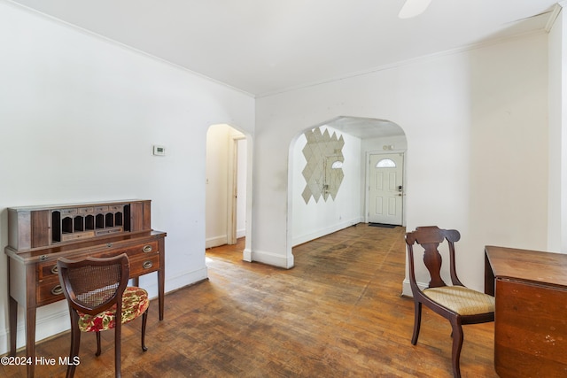 interior space with crown molding and dark wood-type flooring