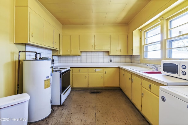 kitchen with decorative backsplash, white appliances, gas water heater, and sink