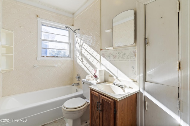 full bathroom featuring vanity, toilet, tile walls, and tiled shower / bath combo