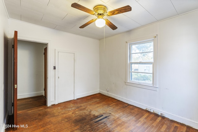 unfurnished room featuring ceiling fan and dark hardwood / wood-style flooring