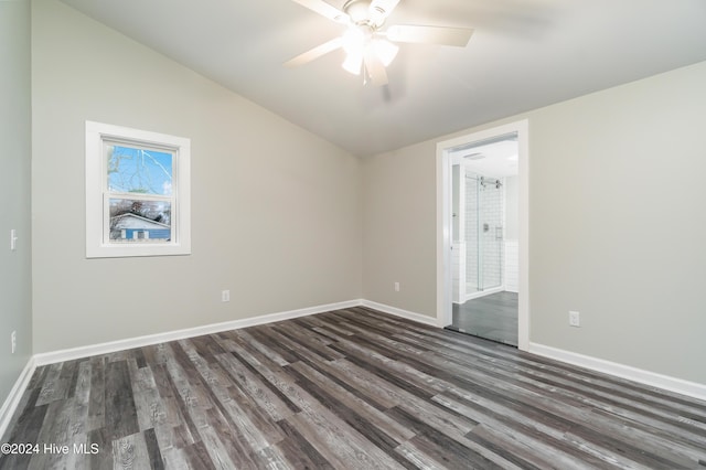 empty room featuring dark wood-type flooring, ceiling fan, and lofted ceiling