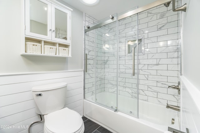 bathroom with toilet and enclosed tub / shower combo