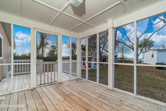 unfurnished sunroom with ceiling fan and coffered ceiling