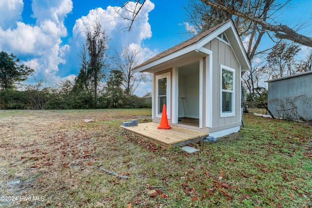 view of outbuilding featuring a yard