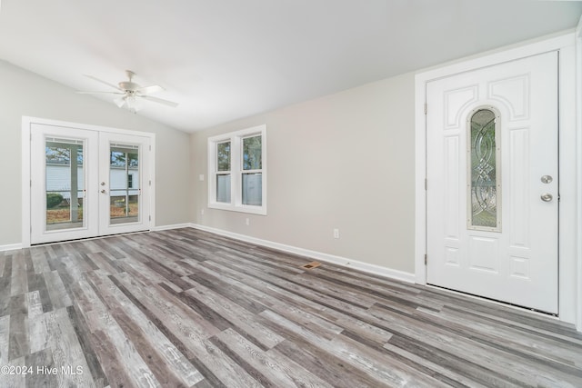 entryway with ceiling fan, french doors, lofted ceiling, and light wood-type flooring