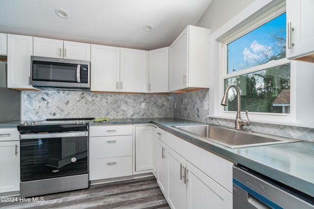 kitchen with dark hardwood / wood-style flooring, white cabinetry, sink, and stainless steel appliances