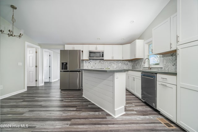 kitchen with white cabinets, decorative light fixtures, and appliances with stainless steel finishes