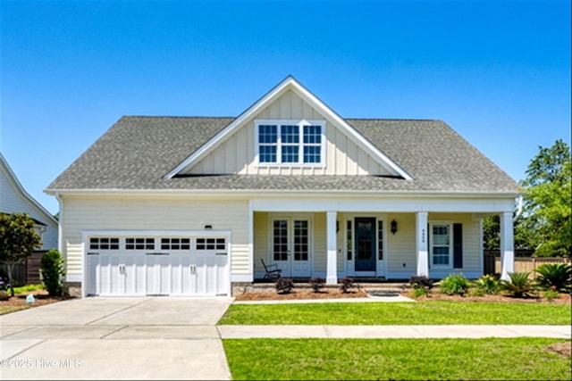 4450 Old Towne St, Wilmington, NC 28412 - modern farmhouse style home with board and batten siding, covered porch, a garage, driveway, and a shingled roof