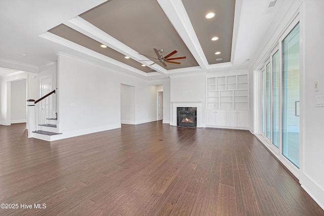 4450 Old Towne St, Wilmington, NC 28412 - unfurnished living room featuring a ceiling fan, dark wood finished floors, stairs, built in features, and a fireplace with flush hearth