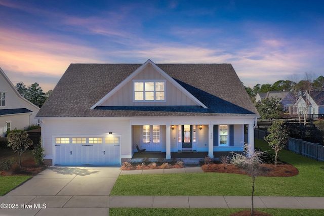 4450 Old Towne St, Wilmington, NC 28412 - modern farmhouse featuring a porch, roof with shingles, a garage, concrete driveway, and board and batten siding