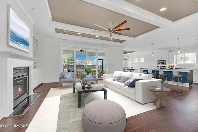 4450 Old Towne St, Wilmington, NC 28412 - living area featuring a ceiling fan, dark wood-type flooring, a fireplace with flush hearth, crown molding, and coffered ceiling
