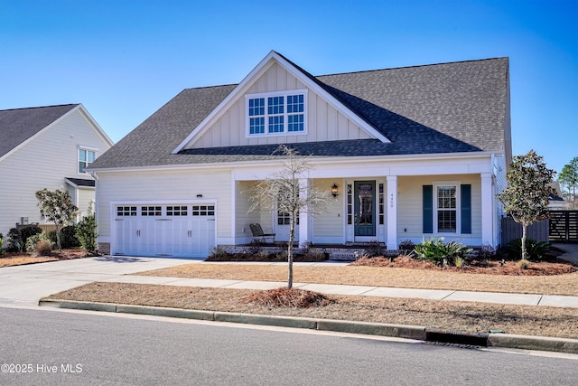 view of front of property featuring a porch, a shingled roof, concrete driveway, board and batten siding, and a garage