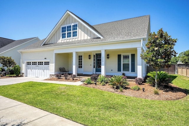 4450 Old Towne St, Wilmington, NC 28412 - view of front of house with board and batten siding, an attached garage, a porch, concrete driveway, and roof with shingles